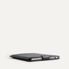 Slim laptop sleeve with MacBook, leather and felt materials, perfect for daily use.