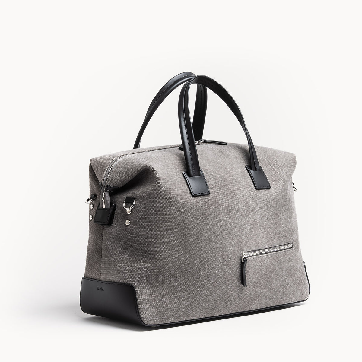 Sac de voyage en toile grise et cuir noir, format cabine 48 heures, design épuré.