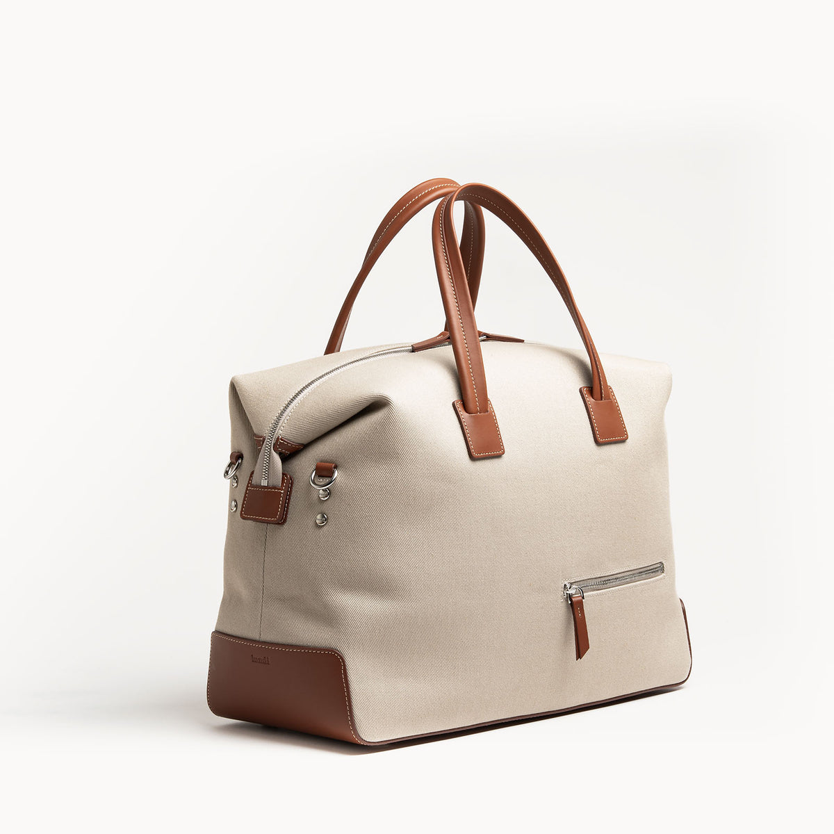 Sac de voyage en toile beige et cuir cognac, format 48 heures, design épuré.
